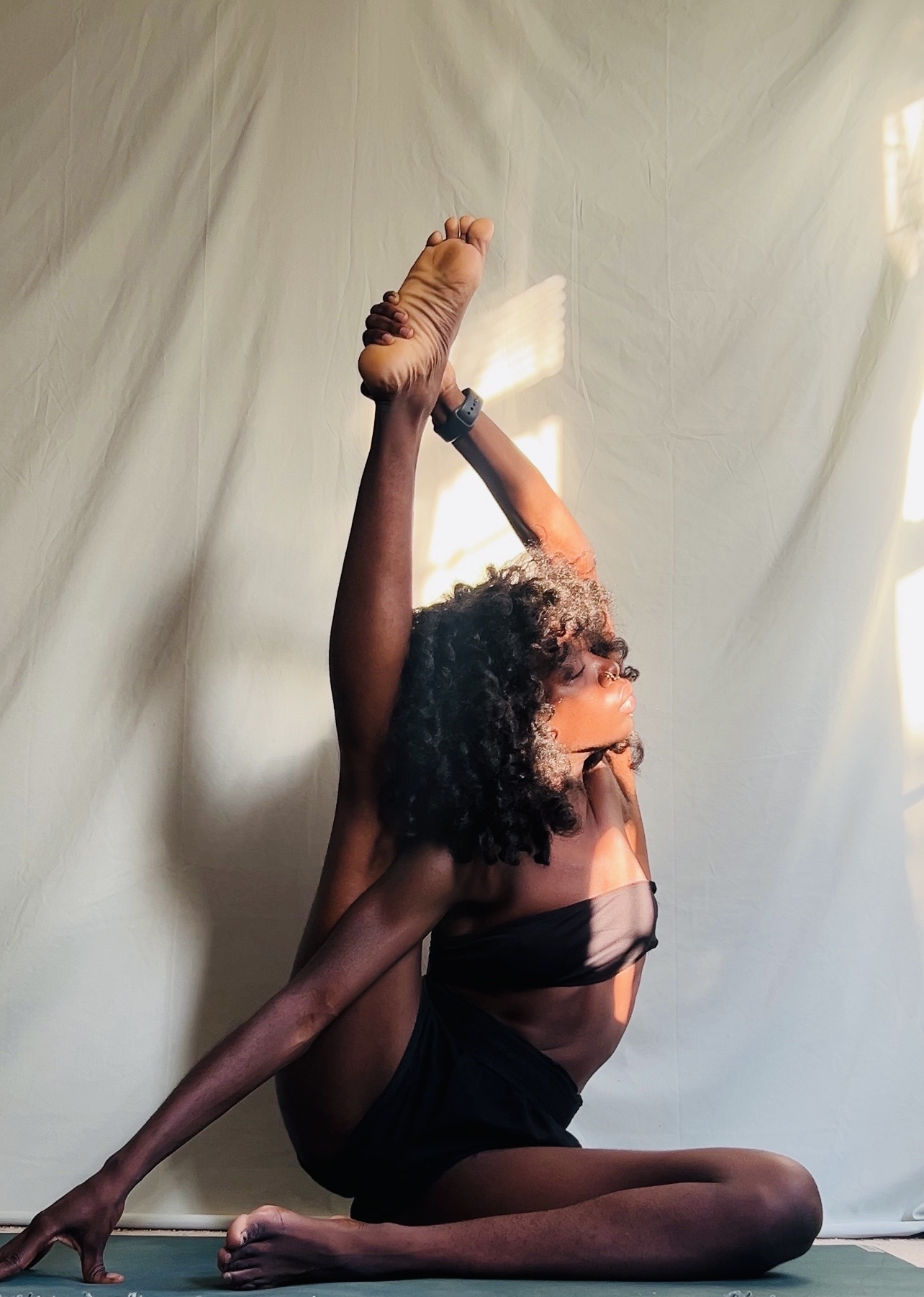 Dalvida in a seated compass stretch